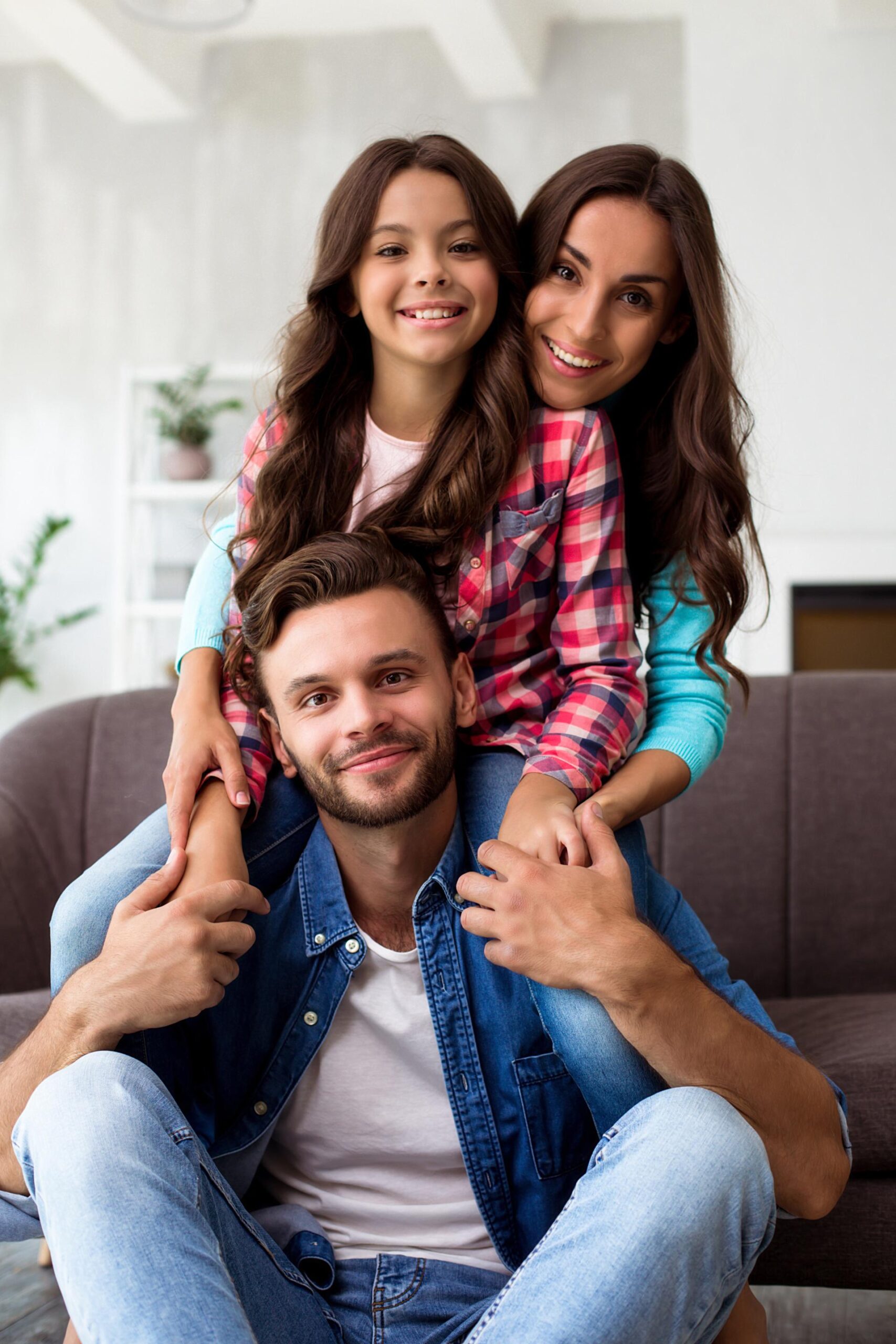 close-up-photo-mother-father-their-daughter-posing-together-joint-photo-their-stylish-living-room-hugging-with-radiant-smiles