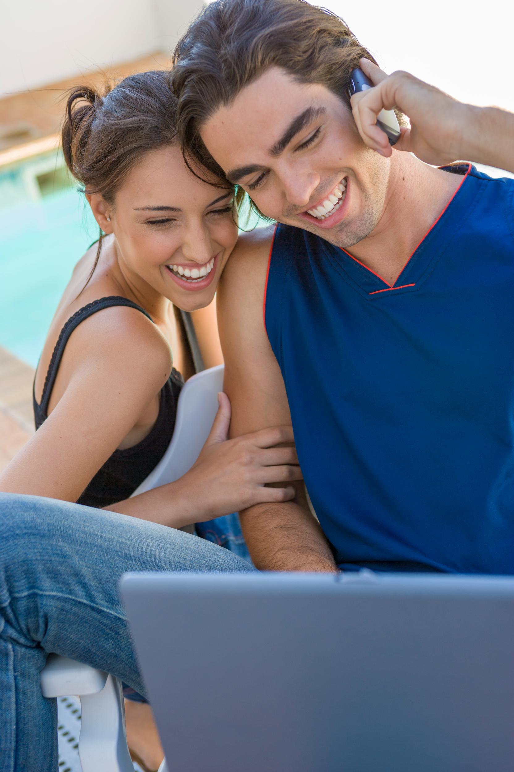 happy-couple-using-technologies-city