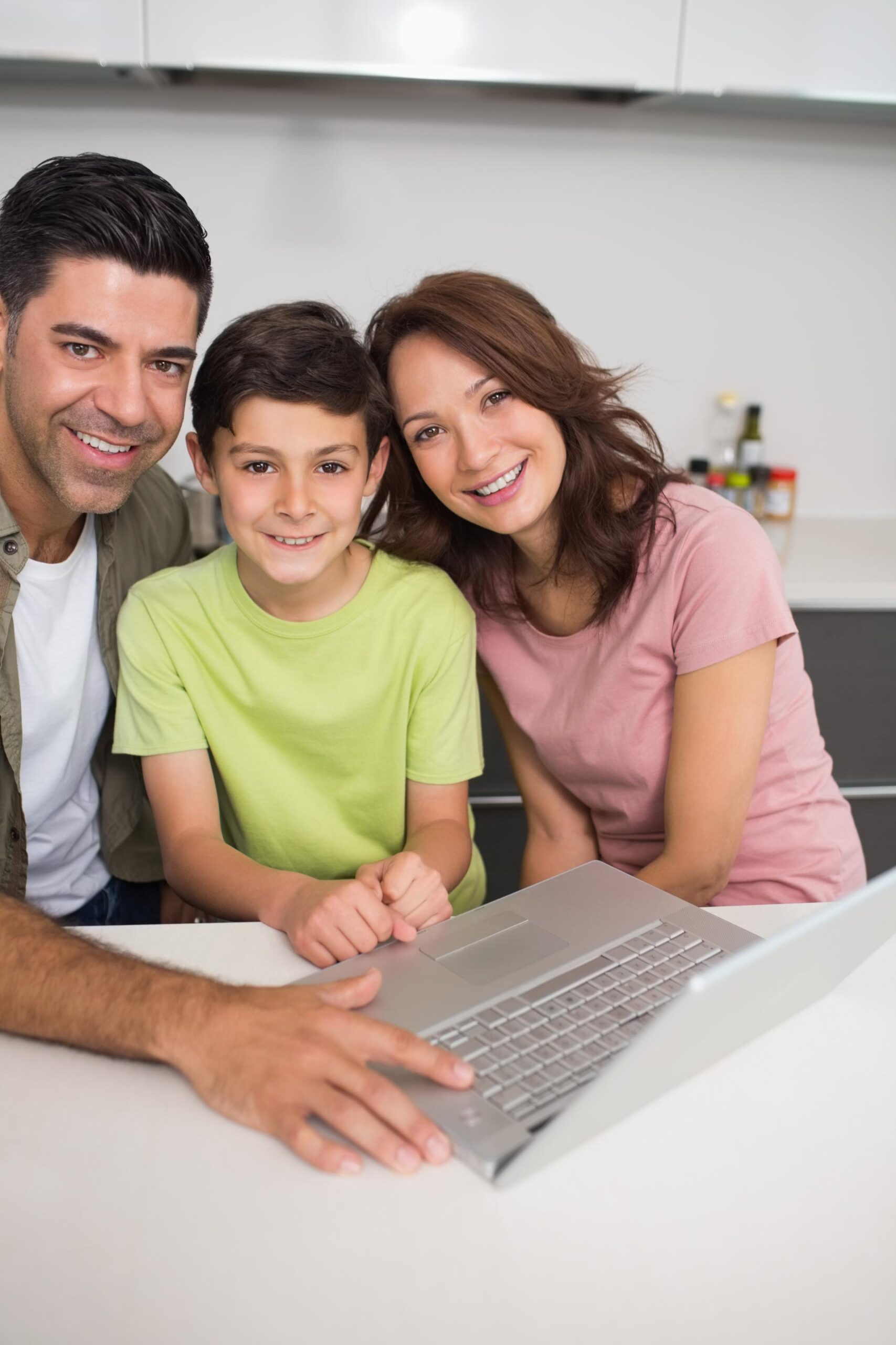 smiling-couple-with-son-using-laptop