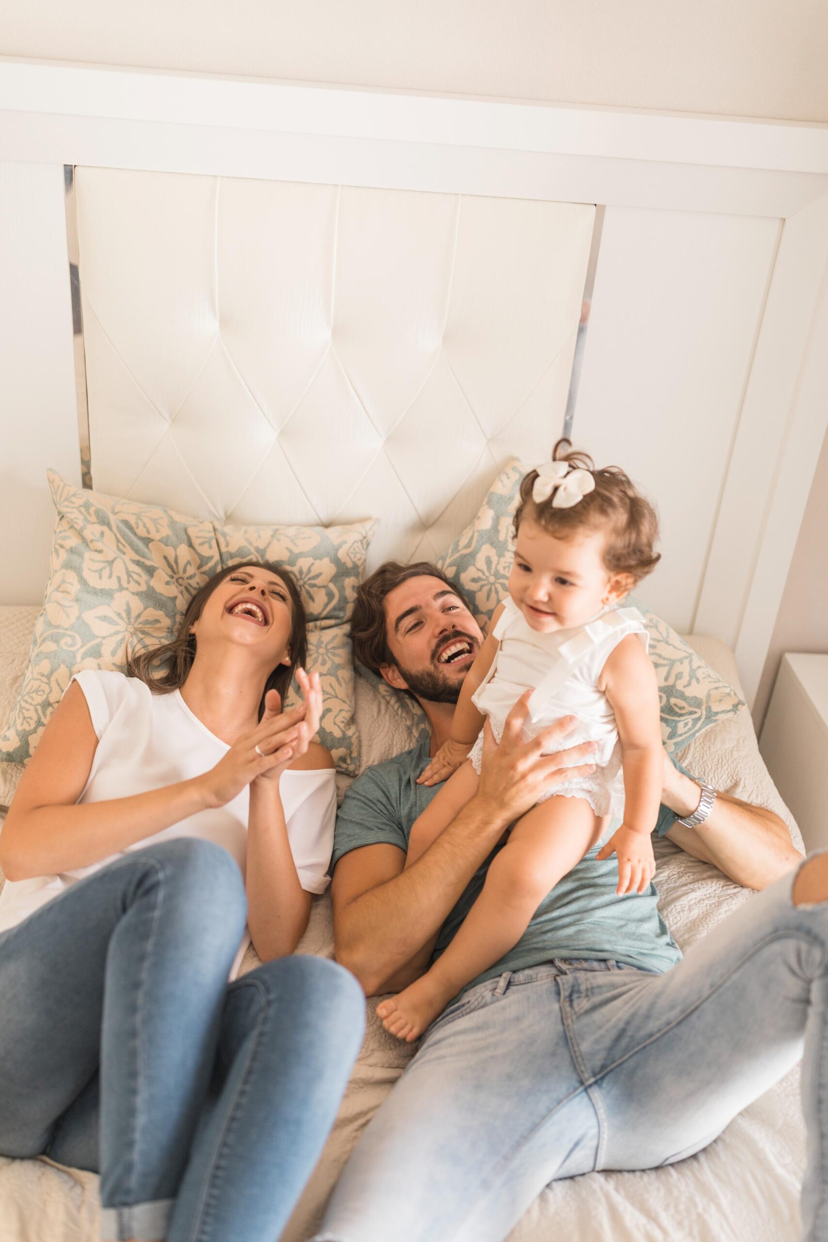 laughing-couple-playing-with-daughter