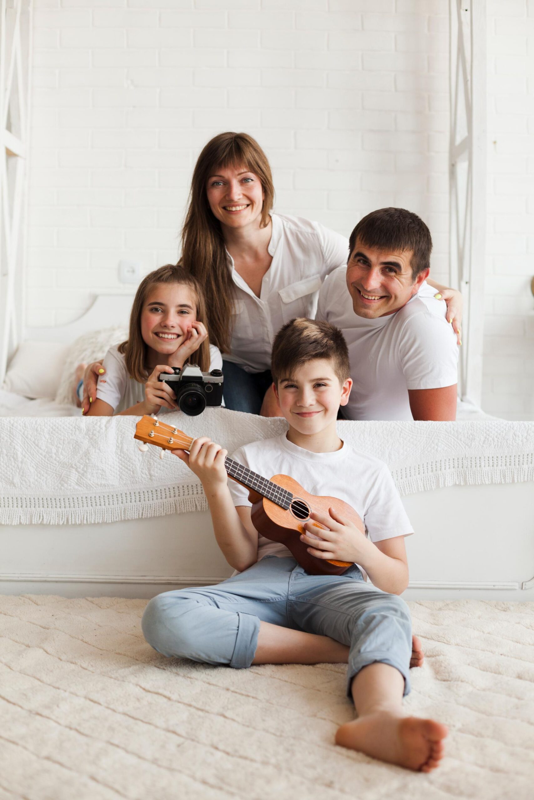 smiling-parent-with-their-children-looking-camera
