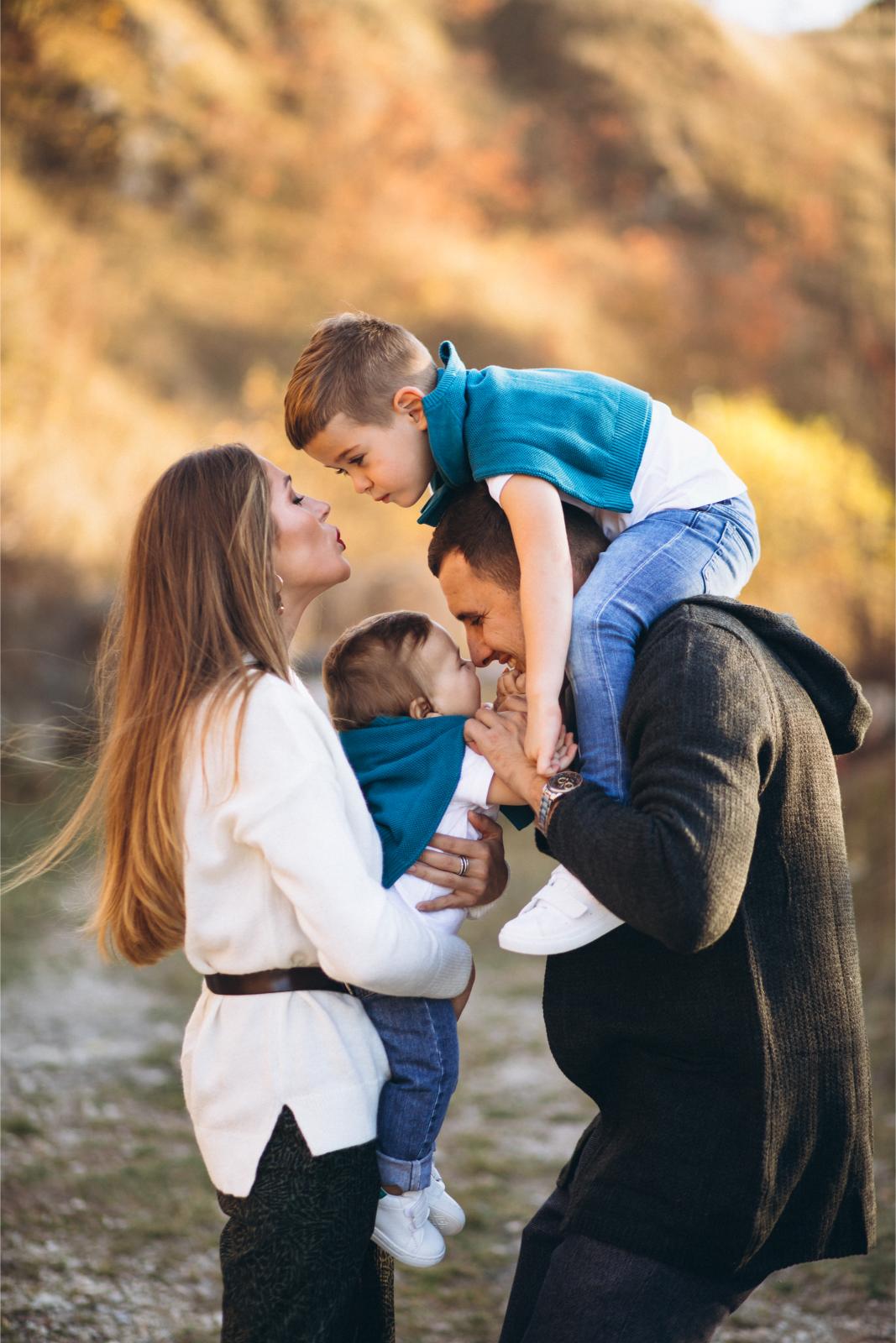 young-family-with-two-sons-together-outside-park